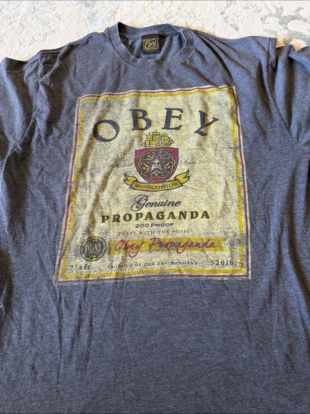 Obey Short-Sleeve Graphic Tee in Navy with Yellow & Red Crest